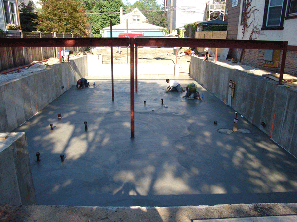 Final touches being put on a freshly poured concrete slab on the North side of Chicago.