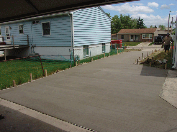 New concrete driveway looking at street from garage slab.