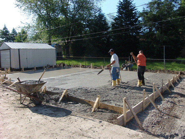 Pouring cement for new 4 car garage slab and side drive.